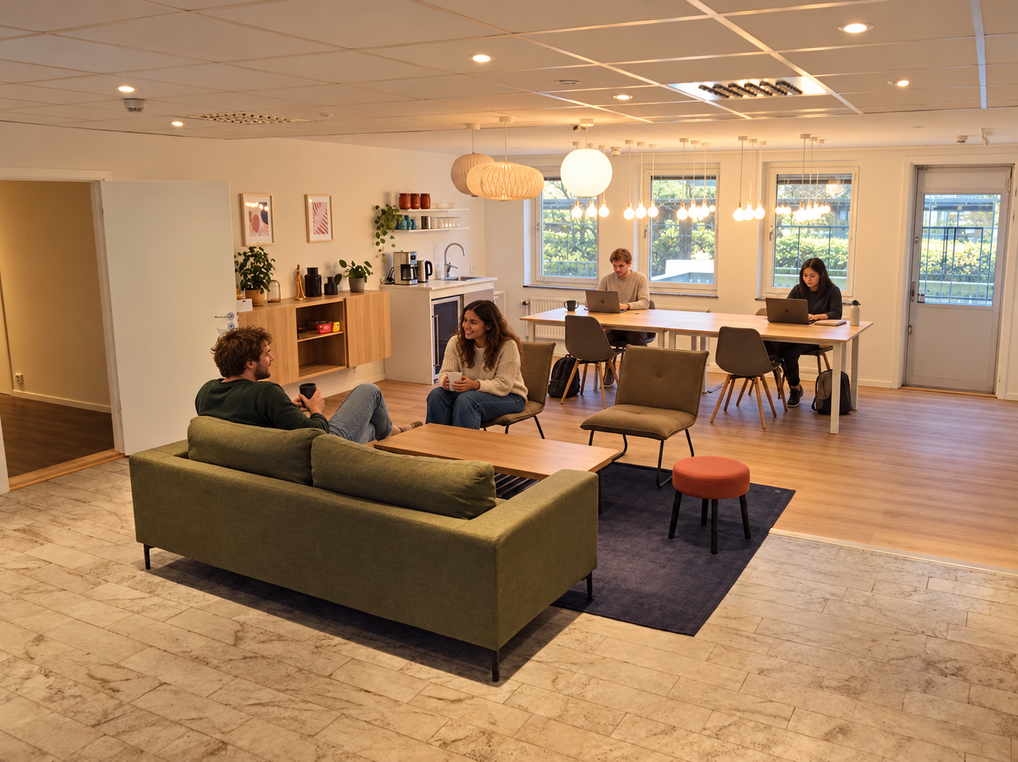 Hoomies residents working and meeting in the coworking lounge